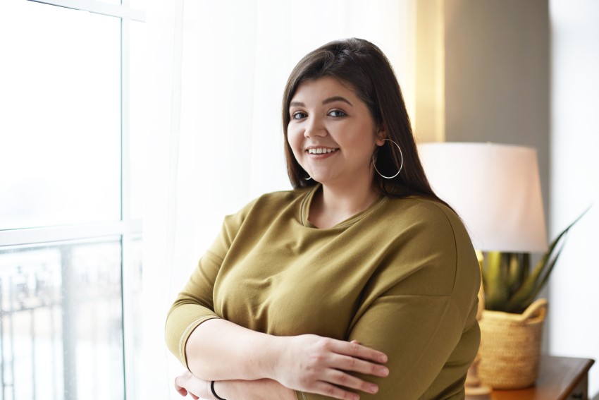 young woman with arms crossed looking at the camera